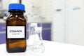 Selective focus of ethanol or ethyl alcohol in brown glass bottle inside a laboratory. Royalty Free Stock Photo