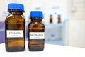 Selective focus of ethanol and methanol brown amber glass bottle inside a laboratory. Blurred background with copy space.