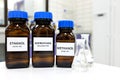 Selective focus of ethanol, methanol and isopropanol brown amber glass bottles inside a laboratory. Different types of alcohol.