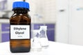 Selective focus of ethylene glycol liquid chemical compound in dark glass bottle inside a chemistry laboratory with copy space.