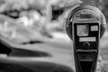 Selective focus on an expired parking meter with no time left.