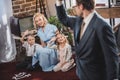 selective focus of father going to work and waving hand to happy family