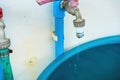 Selective focus faucet water tap not closed properly caused water leaked and dropped into vintage jar. Not safe water, energy, Royalty Free Stock Photo