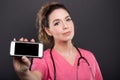 Selective focus of female doctor holding black screen smartphone