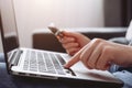 Selective focus of female hands of person entering credit card data laptop computer during pay for internet shopping online Royalty Free Stock Photo