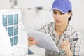 selective focus female worker repairing air conditioner Royalty Free Stock Photo