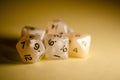 Selective focus, five 12-sided white dice on yellow background dice for role-playing games Royalty Free Stock Photo