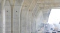 Focus on foreground at flyover expressway foundations structure in under construction over the bridge with passing vehicle Royalty Free Stock Photo