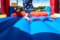 Selective focus on foreword edge of a bouncy house with blurred children playing in the background Royalty Free Stock Photo