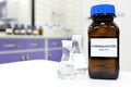 Selective focus of formaldehyde or formalin in brown amber glass bottle inside a laboratory.