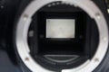 dslr digital camera without body cap showing the mirror and camera sensor, defocused open old dslr digital camera Royalty Free Stock Photo