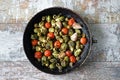 Brussels sprouts with vegetables and herbs in a pan. Cooking Brussels sprouts. Vegan food. Selective focus. Royalty Free Stock Photo