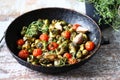 Brussels sprouts with vegetables and herbs in a pan. Cooking Brussels sprouts. Vegan food. Selective focus. Royalty Free Stock Photo