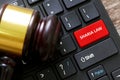 Selective focus of a gavel and a keyboard with red button written with Sharia Law