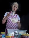 Selective focus. Girl sifting flour adding baking ingredients. Home bakery