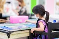 Selective focus. Girl wearing cloth face mask painting on canvas. Kid made art paint watercolor. Child in black apron uniform. Royalty Free Stock Photo