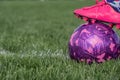 Selective focus on girls' soccer ball with a player on the grass field. Royalty Free Stock Photo