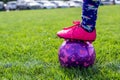 Selective focus on girls' soccer ball with a player on the grass field. Royalty Free Stock Photo