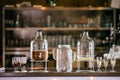 Selective focus of glass bottles of alcoholic drinks with glasses on the bar blurred background Royalty Free Stock Photo