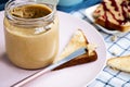 Selective focus. Glass jar with peanut butter, peanuts Royalty Free Stock Photo