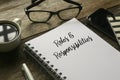 Selective focus of a glasses, coffee,mobile phone,pen and notebook written with Roles and Responsibilities on wooden background Royalty Free Stock Photo