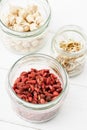 Selective focus of goji berries and sprouts in glass jars Royalty Free Stock Photo