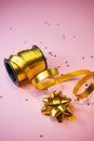 selective focus, gold gift ribbon on pink background, copyspace