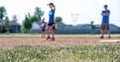 Selective focus on grass with blurred girls softball game in the background Royalty Free Stock Photo