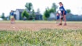 Selective focus on grass with blurred girls softball game in the background Royalty Free Stock Photo