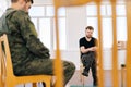 Selective focus of group male soldiers in camouflage uniform talking sitting in circle during PTSD group therapy session Royalty Free Stock Photo