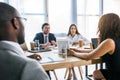 selective focus of group of multiethnic business colleagues discussing strategy during business meeting