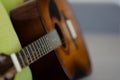 Selective focus guitar fretboard with strings on blurred gray background with copy space. Music concept. Guitar neck texture. Gray Royalty Free Stock Photo