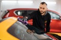 Selective focus on hand of car wash worker man, wearing protective gloves Royalty Free Stock Photo