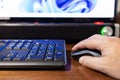 Selective focus on a hand that is clicking on a mouse