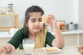 Selective focus on hand of cute Pakistani little Muslim child girl in traditional clothes holding crackers, having breakfast at Royalty Free Stock Photo