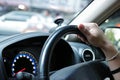 Selective focus on hand of driver on steering wheel of car Royalty Free Stock Photo