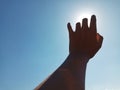 Selective Focus of A Hand Reaching Out Towards the Sky with Sky Background Royalty Free Stock Photo