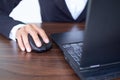 Selective focus Hand using mouse computer laptop. Royalty Free Stock Photo