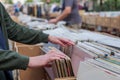 Pick and select second hand phonograph discs in the paper box at flee market.