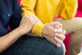 Selective focus at hands. Close up shot of young male homosexual or LGBT couple holding hands and embrace to show love expression Royalty Free Stock Photo