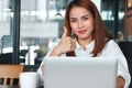 Selective focus on hands of confident young Asian business woman shows thumbs up hands sign in office. Royalty Free Stock Photo