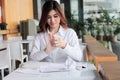 Selective focus on hands of exhausted anxiety young Asian employee holding crumpled paper and feeling stress against her job in of