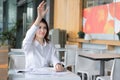 Selective focus on hands of frustrated Asian businesswoman throwing crumple paperwork in workplace. Stressed business concept