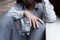 Selective focus on hands of Frustrated stressed young Asian business man sitting on the floor