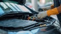 Selective focus hands in gloves of expert technicain electric car, EV car while opened A used Lithium-ion car battery before its