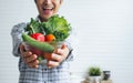 Selective focus on hands holding bowl of vitamin, nutrition vegetables for good health with blur background of man smiling with Royalty Free Stock Photo