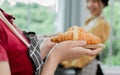 Selective focus on hands holding croissants to serve customers in weekend after preparing in comfortable indoor kitchen at home