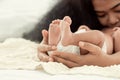 Selective focus on hands holding infant's feet Royalty Free Stock Photo