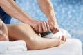 Selective focus of hands of masseur doing massage of arm Royalty Free Stock Photo