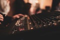 Selective focus of hands mixing music on a professional controller board Royalty Free Stock Photo